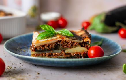 Fitness Recipe: Moussaka

<!-- wp:heading -->
<h1>Fitness Recipe: Moussaka</h1>
<!-- /wp:heading -->

<!-- wp:paragraph -->
This classic Greek dish can be adapted for a healthier twist. Here’s a lighter version of moussaka, perfect for a satisfying and nutritious meal.
<!-- /wp:paragraph -->

<!-- wp:paragraph -->
<strong>Ingredients:</strong>
<!-- /wp:paragraph -->

<!-- wp:paragraph -->
<em>   500g lean ground lamb or beef
<!-- /wp:paragraph -->

<!-- wp:paragraph -->
</em>   1 large onion, chopped
<!-- /wp:paragraph -->

<!-- wp:paragraph -->
<em>   2 cloves garlic, minced
<!-- /wp:paragraph -->

<!-- wp:paragraph -->
</em>   1 tbsp olive oil
<!-- /wp:paragraph -->

<!-- wp:paragraph -->
<em>   1 tsp dried oregano
<!-- /wp:paragraph -->

<!-- wp:paragraph -->
</em>   1/2 tsp cinnamon
<!-- /wp:paragraph -->

<!-- wp:paragraph -->
<em>   400g chopped tomatoes
<!-- /wp:paragraph -->

<!-- wp:paragraph -->
</em>   1/4 cup dry red wine (optional)
<!-- /wp:paragraph -->

<!-- wp:paragraph -->
<em>   Salt and pepper to taste
<!-- /wp:paragraph -->

<!-- wp:paragraph -->
</em>   2 large eggplants, sliced
<!-- /wp:paragraph -->

<!-- wp:paragraph -->
<em>   2 potatoes, sliced
<!-- /wp:paragraph -->

<!-- wp:paragraph -->
</em>   500ml béchamel sauce (light version)
<!-- /wp:paragraph -->

<!-- wp:paragraph -->
*   1/4 cup grated Parmesan cheese (optional)
<!-- /wp:paragraph -->

<!-- wp:paragraph -->
<strong>Instructions:</strong>
<!-- /wp:paragraph -->

<!-- wp:paragraph -->
1.  Preheat oven to 180°C (350°F).
<!-- /wp:paragraph -->

<!-- wp:paragraph -->
2.  Heat olive oil in a large pan. Add onion and cook until softened. Add garlic and cook for another minute.
<!-- /wp:paragraph -->

<!-- wp:paragraph -->
3.  Add ground meat and cook until browned. Drain off any excess fat.
<!-- /wp:paragraph -->

<!-- wp:paragraph -->
4.  Stir in oregano, cinnamon, salt, pepper, and chopped tomatoes. If using, add red wine. Simmer for 15-20 minutes, or until sauce has thickened.
<!-- /wp:paragraph -->

<!-- wp:paragraph -->
5.  Lightly grill or bake eggplant and potato slices until slightly softened.
<!-- /wp:paragraph -->

<!-- wp:paragraph -->
6.  Layer eggplant, potato, and meat sauce in a baking dish. Top with béchamel sauce and Parmesan cheese (if using).
<!-- /wp:paragraph -->

<!-- wp:paragraph -->
7.  Bake for 30-40 minutes, or until golden brown and bubbly.
<!-- /wp:paragraph -->

<!-- wp:paragraph -->
8.  Let cool slightly before serving.
<!-- /wp:paragraph -->